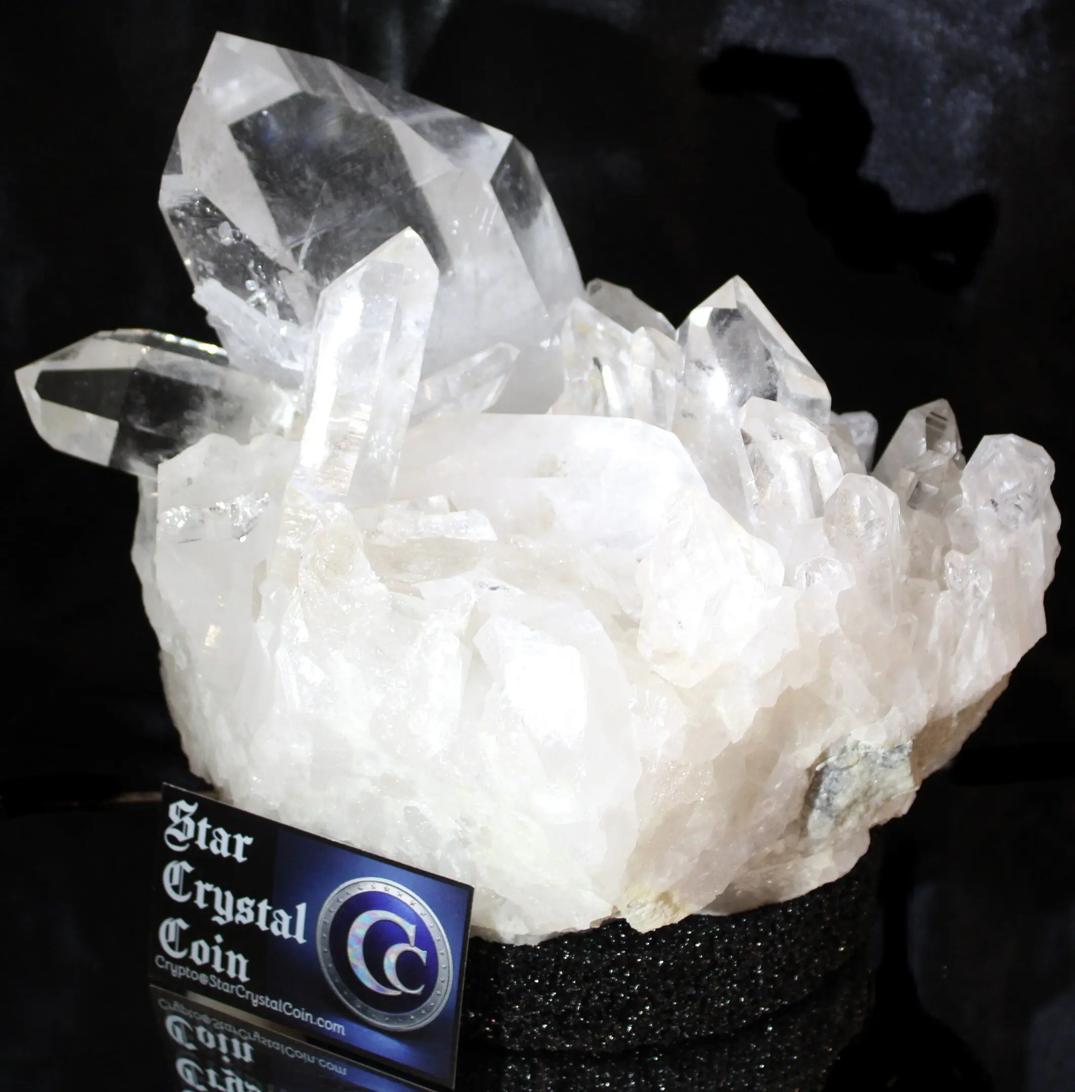 Large clear quartz crystal cluster on display.