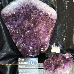 Two clusters of vibrant purple amethyst crystals on display.