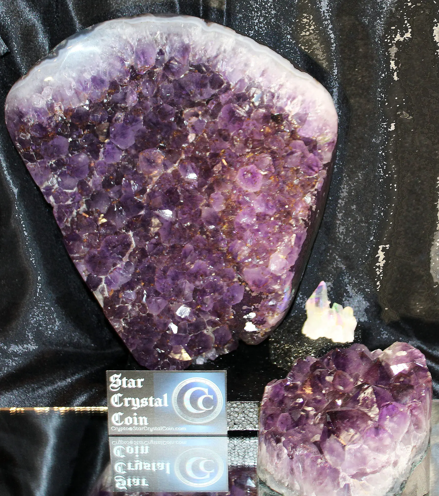 Two clusters of vibrant purple amethyst crystals on display.