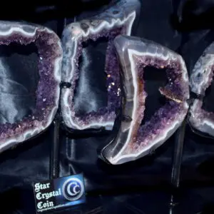 Amethyst geode bookends on black display.