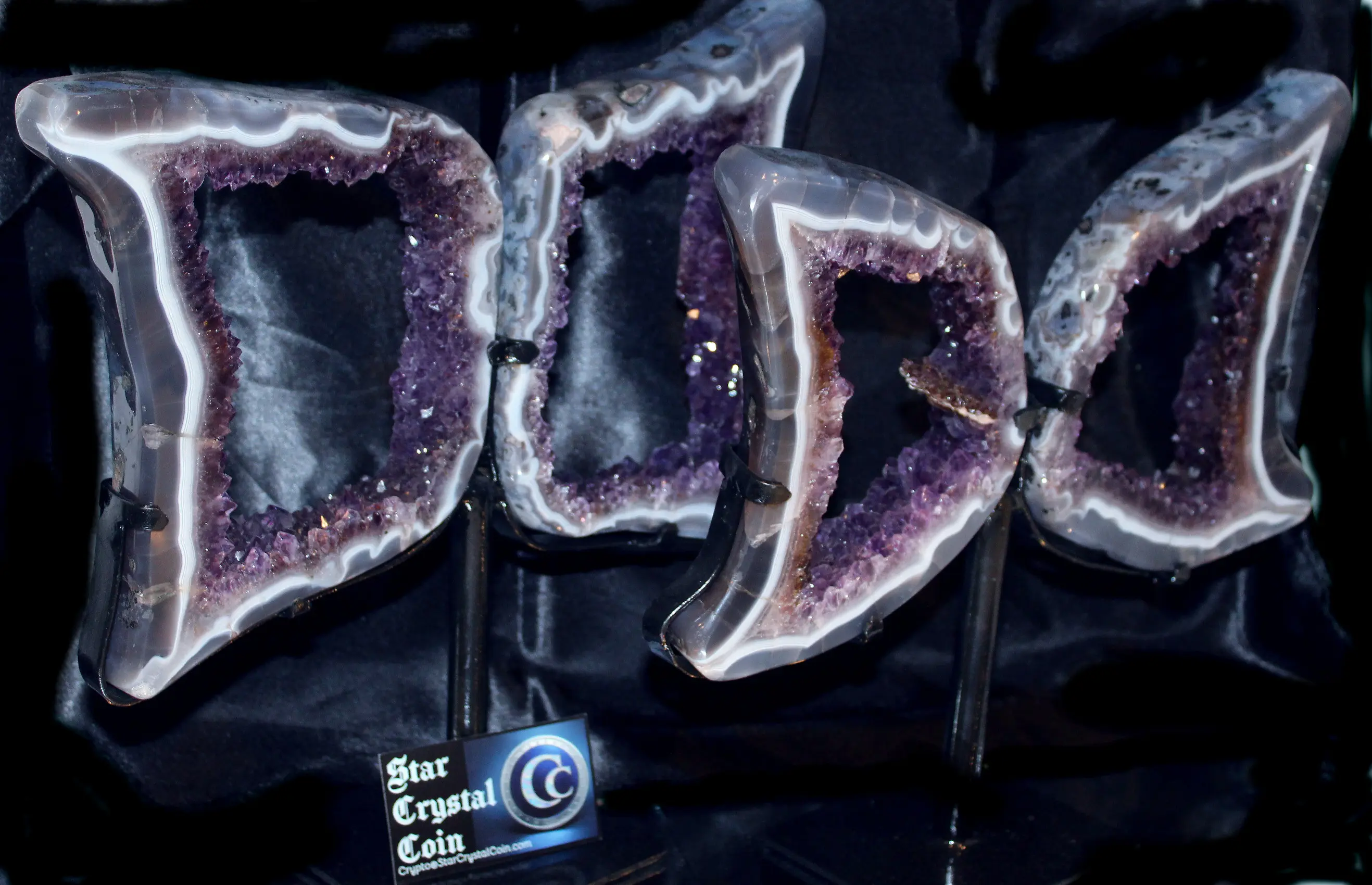 Amethyst geode bookends on black display.